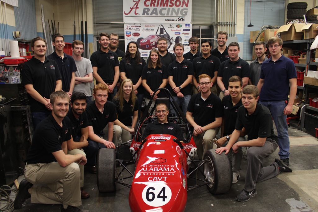 Members of the 2016 FSAE team with last year's car. 