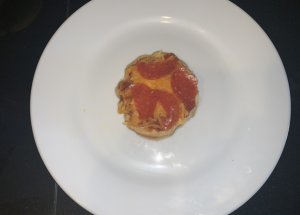 Mini pizza with pepperoni on a plate