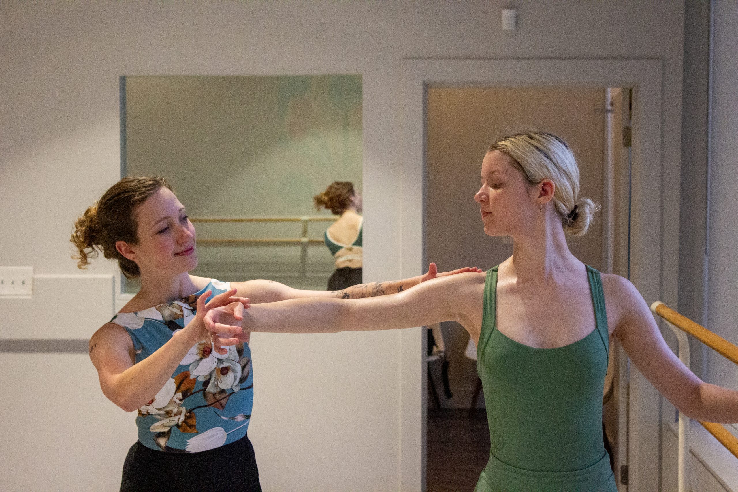 Katie O'Harra instructing her student, Jean Leah, on a barre.